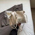 Cream colored faux leather shell bucket bag with drawstring closure and chain strap - White