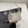 Minimalist white underarm bucket bag with a silver beaded bow charm and thin strap - White with Pendant