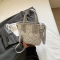 Detail of embroidered mini bucket bag with floral patterns, tassels and adjustable strap - Gray