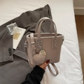 Taupe lychee pattern bucket bag with heart charm and adjustable strap for women - Gray