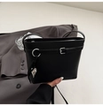 Detailed close-up of black lychee grain bucket bag with buckle and silver leaf charm - Black