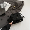 Black drawstring bucket bag with pleated texture and gold chain strap in a fashion set - Black