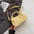 Pale yellow pleated crossbody bag with twisted top handle and slim shoulder strap - Yellow