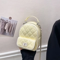 Pale yellow quilted mini backpack with silver chain strap and metal turn-lock closure - Yellow