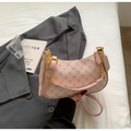 Close-up of pink monogram pattern and golden hardware on the crescent shoulder bag - Pink