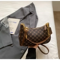 Detailed close-up of retro brown monogram baguette bag with golden chain and leather strap - Coffee