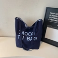 Dark blue canvas tote bag with letter print, bow tie closure and blue checkered lining - Blue