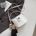 White patent leather bucket crossbody bag with silver clasp and cute doll charm - White with Pendant