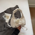 Detail der cremeweißen Handtasche mit gerafftem Griff, Herz-Perlenanhänger und Spitze - Off-White Mit Anhänger