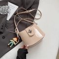 Chic beige bucket bag in glossy patent leather with cute doll charm and silver lock - Khaki with Pendant