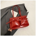 Red glossy patent leather shoulder bag with pockets and bow ribbons in a stylish design - Red