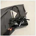 Glossy black underarm bag with bow tie straps in premium faux leather finish - Black