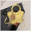 Fashionable bright yellow bucket bag with top handle and brown plush bear charm - Yellow