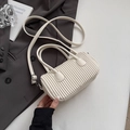 Elegant ivory white pleated cylinder crossbody bag with top handles and adjustable strap - White