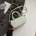 Chic mint green pleated cylinder crossbody bag with top handles and adjustable strap - Green