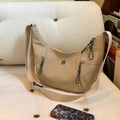 Beige crescent crossbody bag with M-logo, woven zip pullers and wide shoulder strap - Khaki