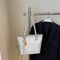 Detail of grey jacquard tote bag with floral patterns and a decorative tassel charm - Gray With Pendant