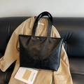 Large black textured leather tote bag with H.SHAN embossed logo on a leather sofa - No Pendant / Black