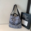 Detail of bohemian canvas tote bag with adjustable strap and metal snap closure - Blue