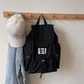 Minimalist black nylon drawstring backpack with flap closure and white woven label logo - Black