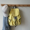 Yellow nylon drawstring backpack with signature patch and matching white baseball cap - Yellow
