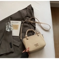 Chic cream white mini bucket bag with gold logo and crossbody strap on grey blazer - No Pendant / Off White