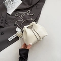 Elegant off-white pleated bucket bag with silver handle and pearl bow charm - White