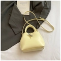 Elegant buttery yellow bucket bag featuring smooth leather finish and metallic toggle closure - Yellow Without Pendant