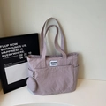 Minimalist lavender nylon tote bag with small round coin purse and white text label - Pink