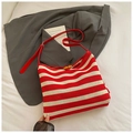 Detail of red and cream striped knitted tote bag with leather straps and button closure - Red