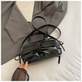 Detailansicht der schwarzen Lackledertasche mit Schleifen und aufgesetzten Taschen - Schwarz