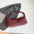 Minimalist burgundy suede underarm bag with silver metal eyelet shoulder strap detail - Red