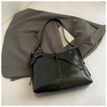 Minimalist glossy black leather shoulder bag with decorative ties on a grey suit jacket - Black without Pendant