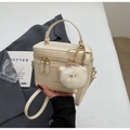 Detail of a beige vanity bag with a plush charm and detachable shoulder strap - Off-white with Charm