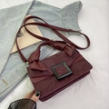 Burgundy faux snakeskin crossbody bag with black square buckle and knotted handle details - Burgundy