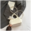 Chic beige bucket bag with lychee texture, featuring a pearl pendant and shoulder strap - White