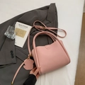 Pink lychee texture leather bucket bag with puppy charm and adjustable strap - Pink