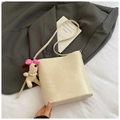 Detalle del bolso de cubo blanco crema con logo SNML, amuleto de peluche y bandolera - Blanco Crema con Colgante