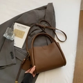 Chic brown litchi leather bucket bag with top handles and a cute dog charm pendant - Coffee