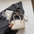 Chic beige bucket bag with faux crocodile texture and gold hardware on a grey blazer - Khaki No Pendant