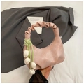 Detailed view of pink pleated handbag with floral tulip charm and ruffled handle - Pink