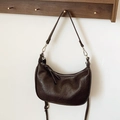 Minimalist dark brown half-moon crossbody bag with wrinkled leather texture and dual straps - Brown