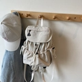 Minimalist beige nylon backpack with drawstring closure and flap cover for casual travel - Off-white