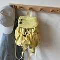 Vibrant yellow nylon drawstring backpack for women featuring flap closure and side pockets - Yellow