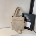 Minimalist beige canvas tote bag with adjustable shoulder strap and large front pocket - Off-white