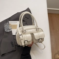 Detalle del bolso bowling blanco crema con bolsillos delanteros con hebilla y herrajes plateados - Blanco Roto