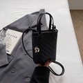 Minimalist black woven mini crossbody bag with a silver heart pendant and shoulder strap - Black