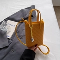 Chic yellow woven mini crossbody bag with heart pendant and long shoulder strap - Yellow