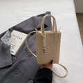 Minimalist cream woven mini tote bag with crossbody strap and silver metallic charm - Off White