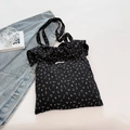 Schwarze Canvas-Tragetasche mit gelbem Blumendruck und eleganten Rüschendetails - Schwarz